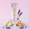 Hand and body butter tube with lavender and sandalwood theme on a pink background