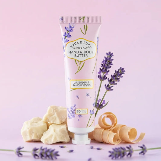 Hand and body butter tube with lavender and sandalwood theme on a pink background